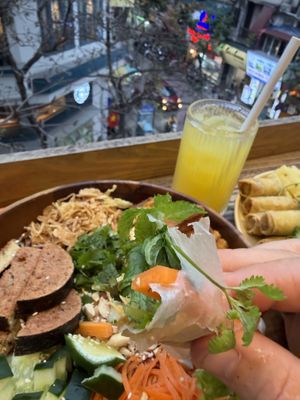 Meal with a view! Saigon bowl, Spring Rolls and Pineapple juice.Very filling, very vegan, very good value.  at iVegan Supershop Old Quarter Hanoi - Healthy Plant Based Cafe in Hanoi