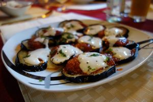 Borani Banjan (fried aubergines in tomato sauce, served with garlicky yoghurt and herbs) (vegan) at Weissberg Restaurant in Saarbrucken