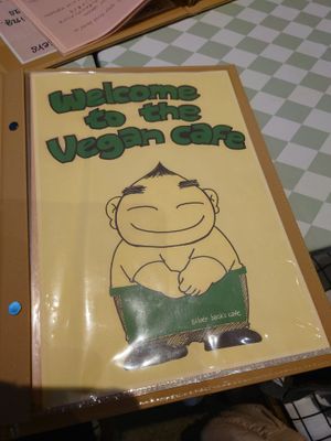 The owner pictured on the menu at Silver Backs Cafe in Kyoto