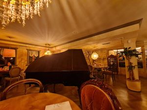 Beautifully decorated restaurant with piano, wall paitings and antique furniture at Marie Miner Gastrospace in Santiago De Compostela