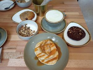 Pancakes with salted caramel and pears, cookies, yogurt and granola at Nöje   in Brussels