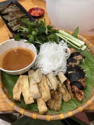 Tofu, noodles and shrimp sauce dish with rice paper sheets, and the rice dumplings shown in the background.   at Nhà Hàng Chay Link Vegan in Da Lat