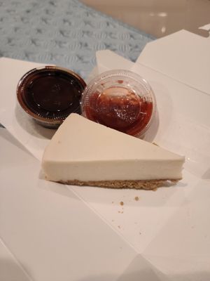 Cheesecake with Strawberry and Chocolate Sauce on the Side at Vegan District Asian Eatery in Anaheim