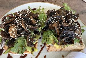 Mushrooms and arugula avocado toast.   at Bugaloe in Noord