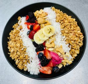Shangri-La Sunrise Smoothie Bowl Organic Açai combined with berries, bananas and cherries topped with homemade granola, coconut, cashews, fresh fruit and rose syrup at Shangri-La Springs in Bonita Springs