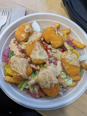 Crispy chicken bowl on fries at Vegholic in Toronto