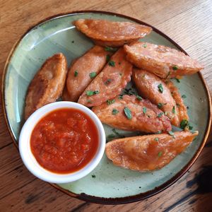 Chickpea snack portion with spicy sauce at Momos - Organic Veggie Dumplings in Berlin