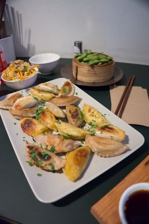 Momos with 3 different vegan fillings; Edamame and salad at Momos - Organic Veggie Dumplings in Berlin