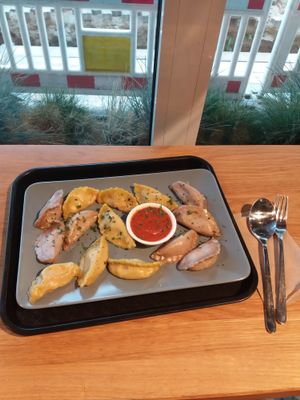 Medium portion (14 dumplings), two types of vegan dumpling: brocolli & shiitake mushroom and pumpkin & chickpea, mitho tomato dip.  at Momos - Organic Veggie Dumplings in Berlin