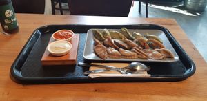 Large menu with lemon and tomato sauce at Momos - Organic Veggie Dumplings in Berlin