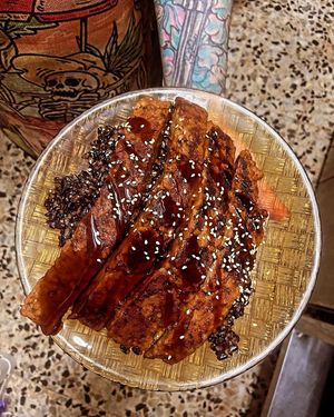 Ribs over black rice at La Galla Tasca Vegana in Barcelona