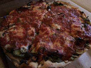 Fully loaded deep dish pizza at Kitchen 17 in Chicago