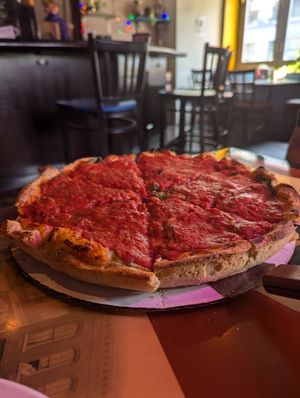 Fully loaded 12" deep dish pizza at Kitchen 17 in Chicago
