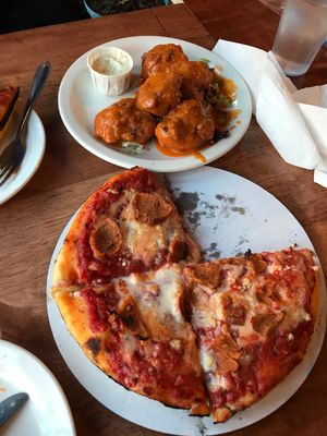 personal deep dish pizza with garlic and pepperoni and buffalo cauliflower wings  at Kitchen 17 in Chicago