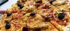 Vegan pizza, "la fabuleuse", tomato sauce, marinated peppers, kalamata olives, aiguillettes (Happyvore) and vegetable rapé, espelette pepper at La Pizza de Nico in Paris