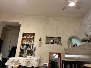Interior with a small store (soy sauce, teriyaki sauce, and black garlic) and books (shelf on the left). at Plantastic Kitchen in Tbilisi