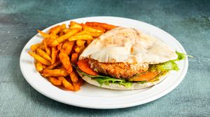 PLUS Burger handwich with jackfruit patty, smoked mayonnaise, cheese, pickles, ketchup, lola lettuce, tomato and crunchy fries at Handwich in Athens