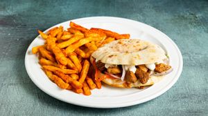 PLUS Kebab Handwich with seitan kebab, coconut yogurt, tomatoes, onions, parsley, sweet paprika and crunchy fries
 at Handwich in Athens