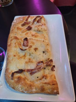 Carbonara and bacon pizza slice at New Freedom Cakes Cafe in Madrid