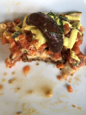 Closer look of a bitten piece of delicious marinara pizza   at Rasayana Raw Food Cafe in Bangkok