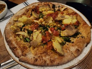 Vegan broccolini and potato pizza (cauliflower crust, cashew cheese, toppings - roasted broccolini, crushed potato, calabrian chilies, tomato, and rosemary) at Sixty Vines in Plano
