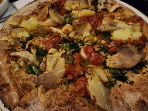 Vegan broccolini and potato pizza (cauliflower crust, cashew cheese, toppings - roasted broccolini, crushed potato, calabrian chilies, tomato, and rosemary) at Sixty Vines in Plano