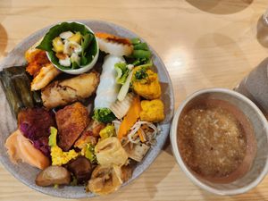 Porridge, fruit spring rolls, cakes, rolls, tofu at Homie Vegan in Hanoi