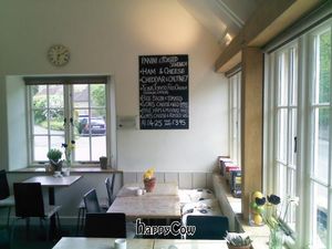 Indoor dining area, with sample menu on the wall at Mells Community Cafe in Mells