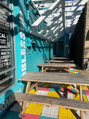 outdoor seating on the side of the restaurant at Koko + Rae Caribbean Kitchen in Louisville