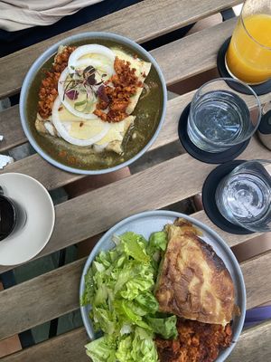 Enchiladas bañadas en salsa verde, fresh mango juice, and tortilla española   at Alguito Vegano in Mexico City