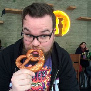 enjoying his vegan pretzel at Katzentempel - München in Munich
