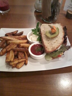 Bean burger and chips with tomato ketchup and sour cream dip at Katzentempel - München in Munich