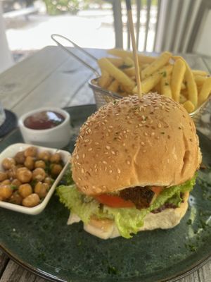 Cauliflower burger with all the fixings including black olive tapenade and hummus. Generous portion of fries!  at Isabelle Off The Beach in Westpunt