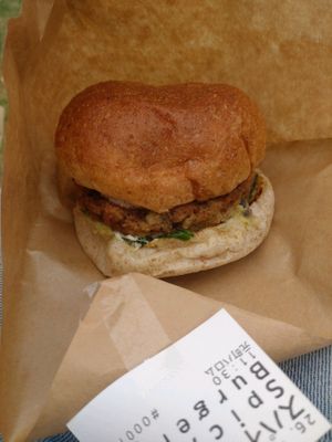 Burger with chili and spinach toppings at Veggie Junkies Burger in Kobe