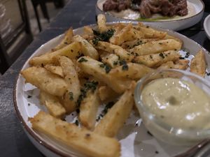 Hand cut chips seasoned with toasted curry leafves  at Smoke & Bitters in Dikwella