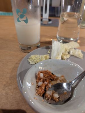 Makgeolli with complimentary jigemi/ deonjang mixture dip with cabbage. delicious both on their own right and a very nice pairing. at Ggulggeok House - 꿀꺽하우스 in Busan