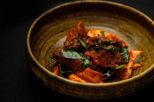 หมูผัดพิโรธ  moo pad piroth
“angry pork” stir-fried with young coconut shoots, 
sweet basil, and green peppercorns
 at Nahm  in Bangkok
