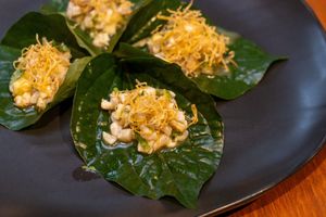 เมี่ยงปลาสะเออะ miang pla sa-er
miang of kam pachi ceviche, white turmeric, and green mango served 
on betel leaf
 at Nahm  in Bangkok