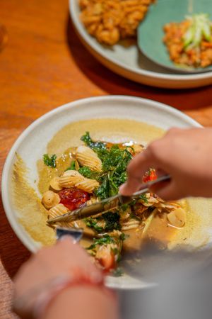 ปลาหมึกผัดไข่เค็มกับหน่อกระวาน   pla muek pad kai khem
charred squid with salted egg and wild cardamom shoots
 at Nahm  in Bangkok