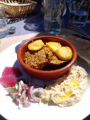 Homemade vegan patties with hummus and potatoes at Entre Terres Restaurant in Girona