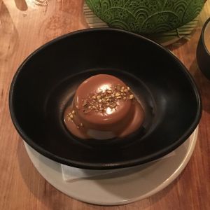Panna cotta au lait de coco, vanille et amande avec sirop espresso at Invitation V in Montreal