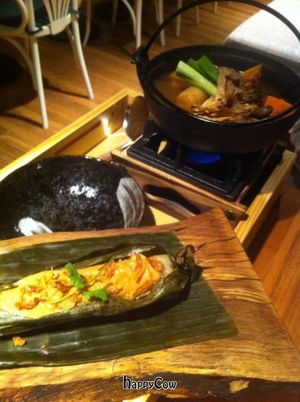 Signature Hot Pot tray featuring our homemade miso broth and tofu with organic vegetables served with creamy coconut Tamale & exotic peanut sauce. at Invitation V in Montreal