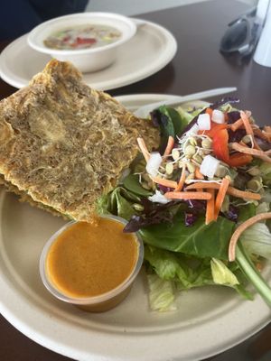 The cheeseburger with the crispy onion bread and a side salad with red pepper dill dressing   at Veggos Green Cuisine in Lake Forest