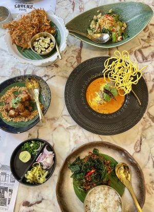 Banana blossom fritters, aubergine & tofu, pork belly, koh soi, Thai basil & mince  at Vegan Mahanakhon in Bangkok