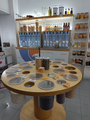 Bulk section with e.g. beans, and taps with wine at Negozio Leggero   in Turin