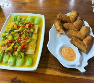 Left, tofu with pineapple sauce. Right, spring rolls at Kiều Đàm in Ho Chi Minh City