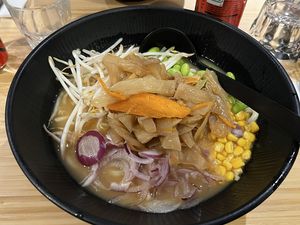 Ramen in miso broth with corn, spring onions, vegetables and edamame  at Ramen Shop in Strasbourg
