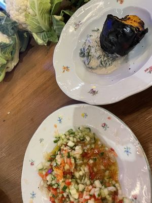 Blacked pumpkin with spinach & labneh cream; Jerusalem salad  at Goli Restaurant in Budapest