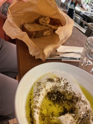 Labneh with fresh zaatar olive oil and a ten your old recipe that no one knows and a bread bag of sour dough and pita  at Goli Restaurant in Budapest