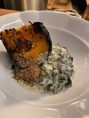 Black pumpkin, crispy sand from her seeds, young spinach steamed in labneh pepper cream   at Goli Restaurant in Budapest